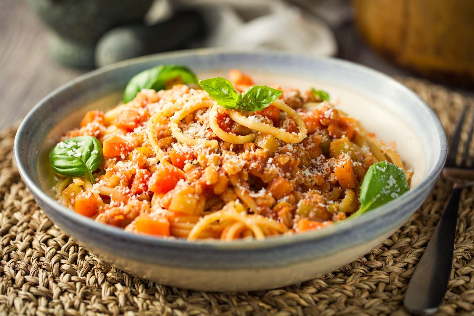 Home made freshness vegan bolognese made by barley,red lentils with tomato basil sauce,carrot,celery with spaghetti and shaved hard coconut cream